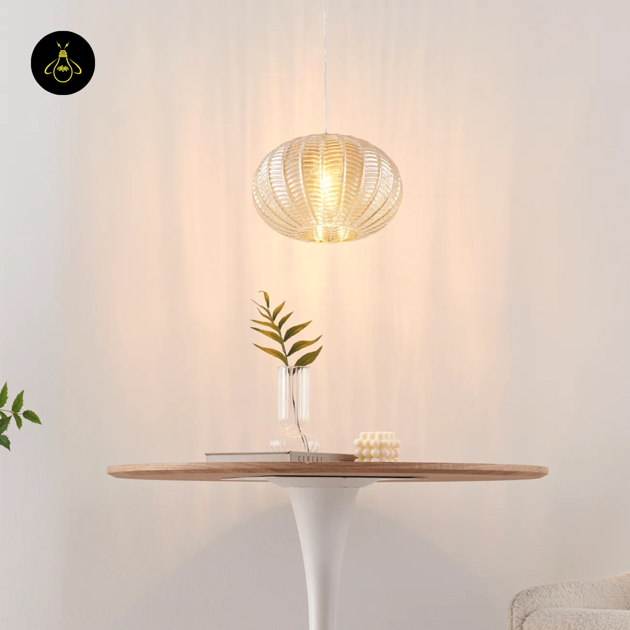 Textured Amber Glass Pendant Light – 26 cm Globe, Brass Finish, E27 11 Lit textured glass pendant light above a round table with a glass vase of leaves