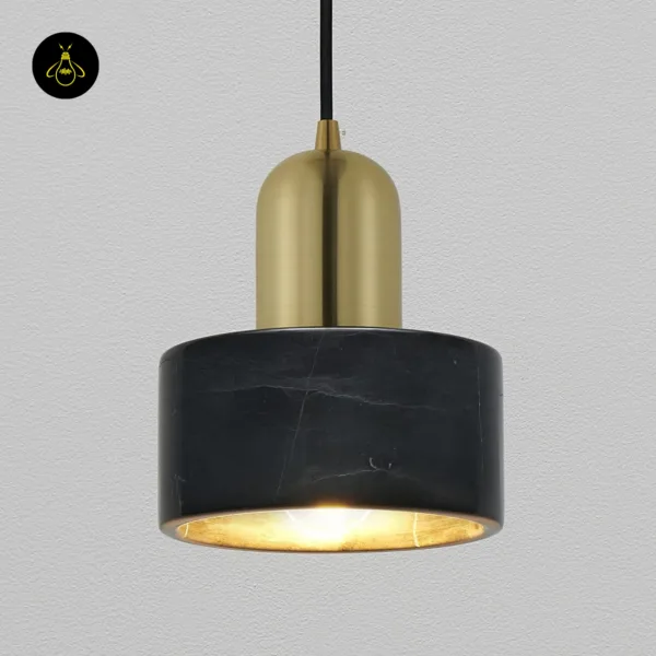 Marble hanging light close-up: black marble drum with pale veins, gold cap and gold-lined underside