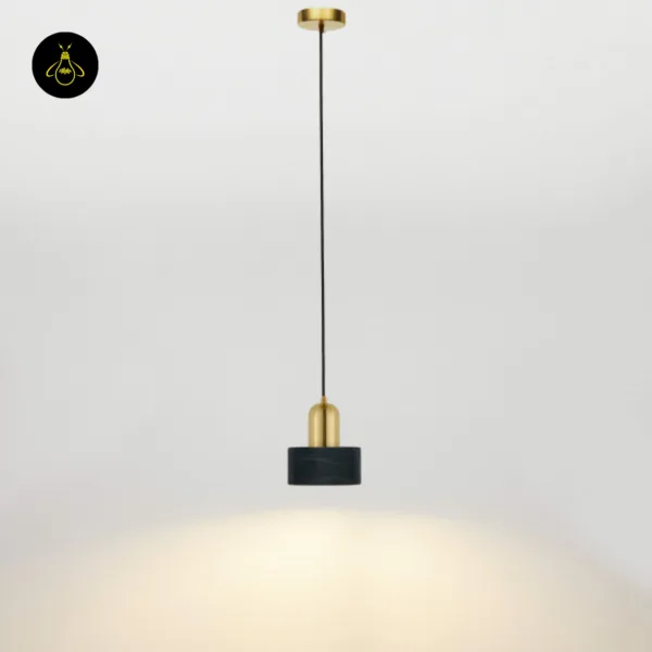 Full view of the marble hanging light: brushed gold canopy, long black cord and black marble drum