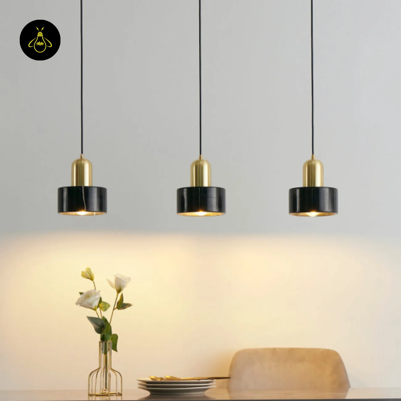Black Marble Pendant Light – Meryl | 15 cm Marble Hanging Light with Gold Cap 5 Three black marble hanging lights in a row above a dining table with flowers and plates