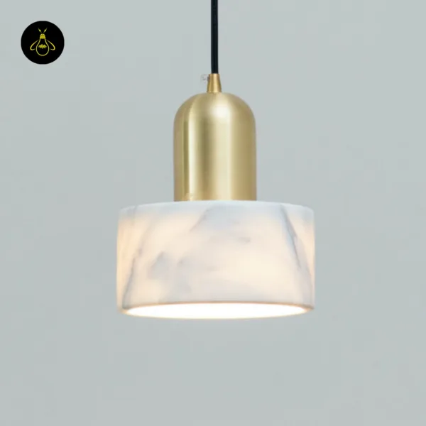 Close-up of the Meryl marble light showing grey veins in the white marble and the brushed gold cap