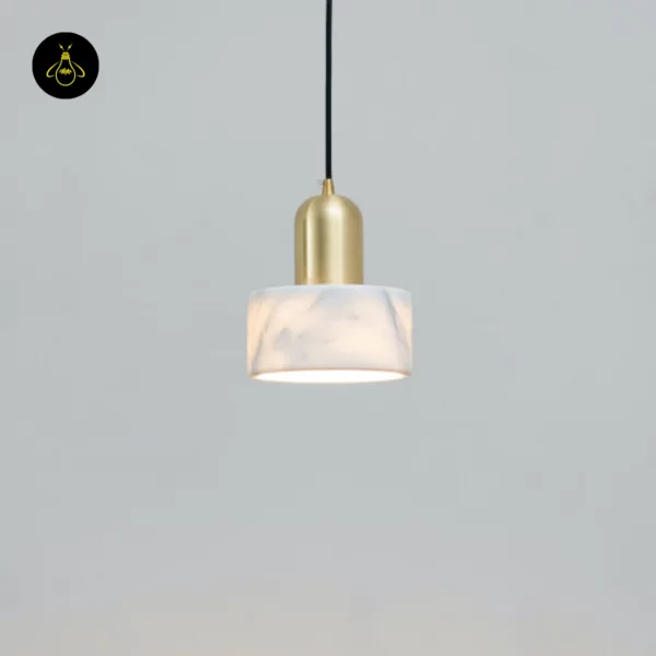 Meryl marble light hanging on a black cord against a pale grey wall, glowing from its open base