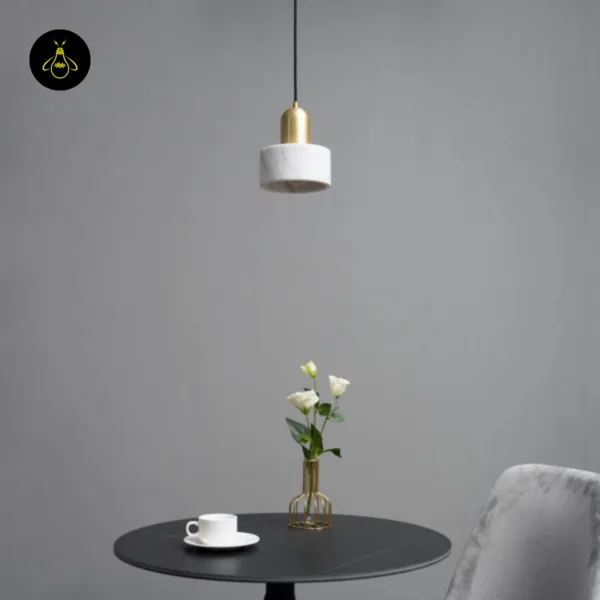 Marble light Meryl, unlit, hanging over a round black table next to a grey chair