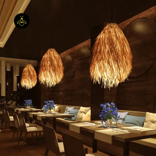 Three rattan pendant lights glowing over a row of dining tables in a restaurant with wood-panelled walls