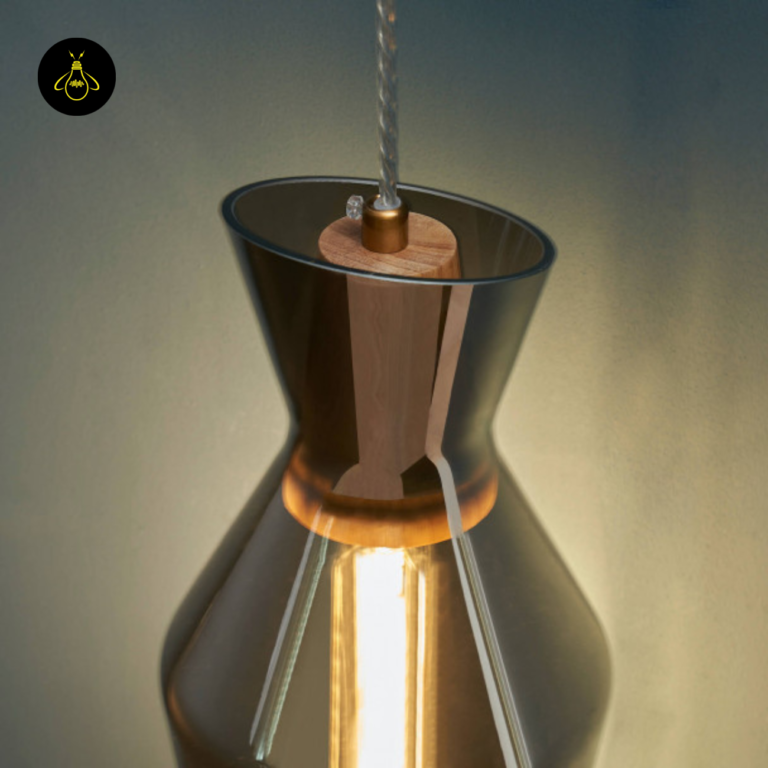 Faceted smoked glass pendant light close-up of the natural-wood top cap and cord