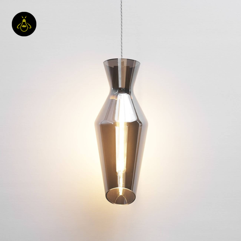 Faceted smoked glass pendant light lit, warm filament glowing through the smoked drop shade