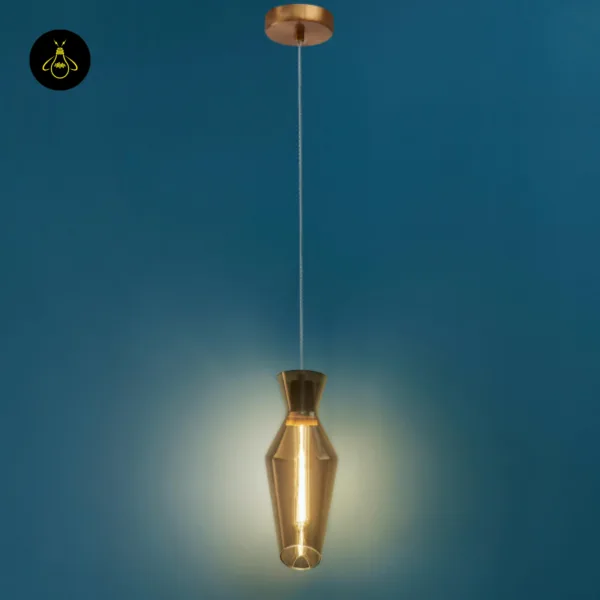 Full drop of the faceted smoked glass pendant light with a round antique brass finish stainless steel canopy, on a teal wall