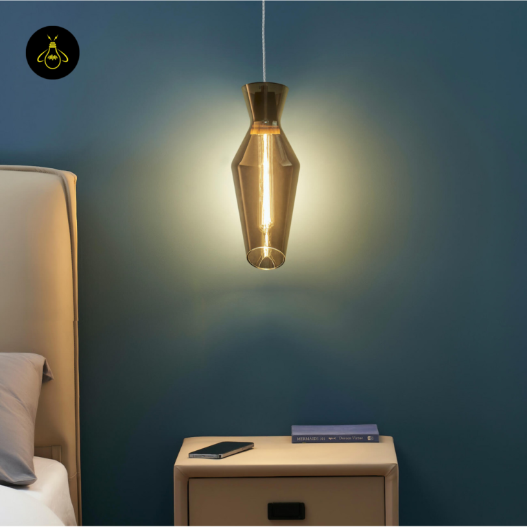Smoked glass pendant light casting a warm glow in a loft-style room