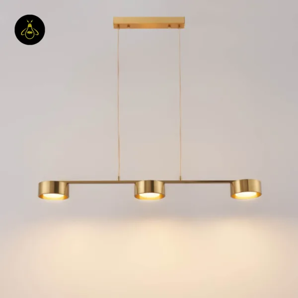 Brass linear chandelier with three integrated-LED drum spots hanging against white – Jagmag Lights