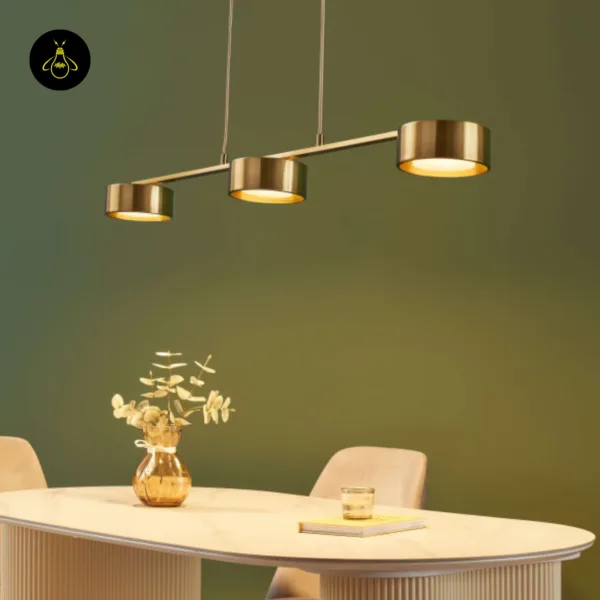 Linear brass chandelier with warm downward spots over a dining table – Jagmag Lights