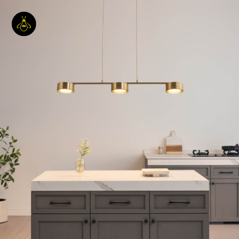 Linear LED pendant light above a kitchen island in brass finish