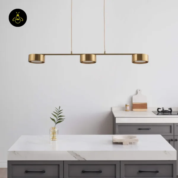 Linear brass chandelier casting warm focused spots over an island counter – Jagmag Lights
