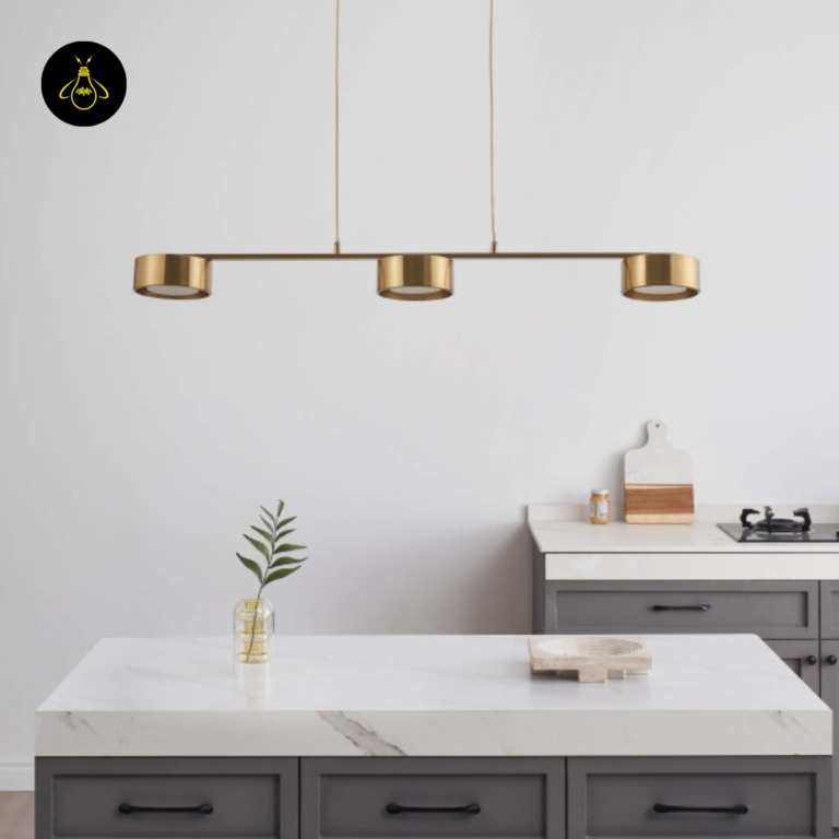 Linear LED pendant light casting warm spots over an island counter