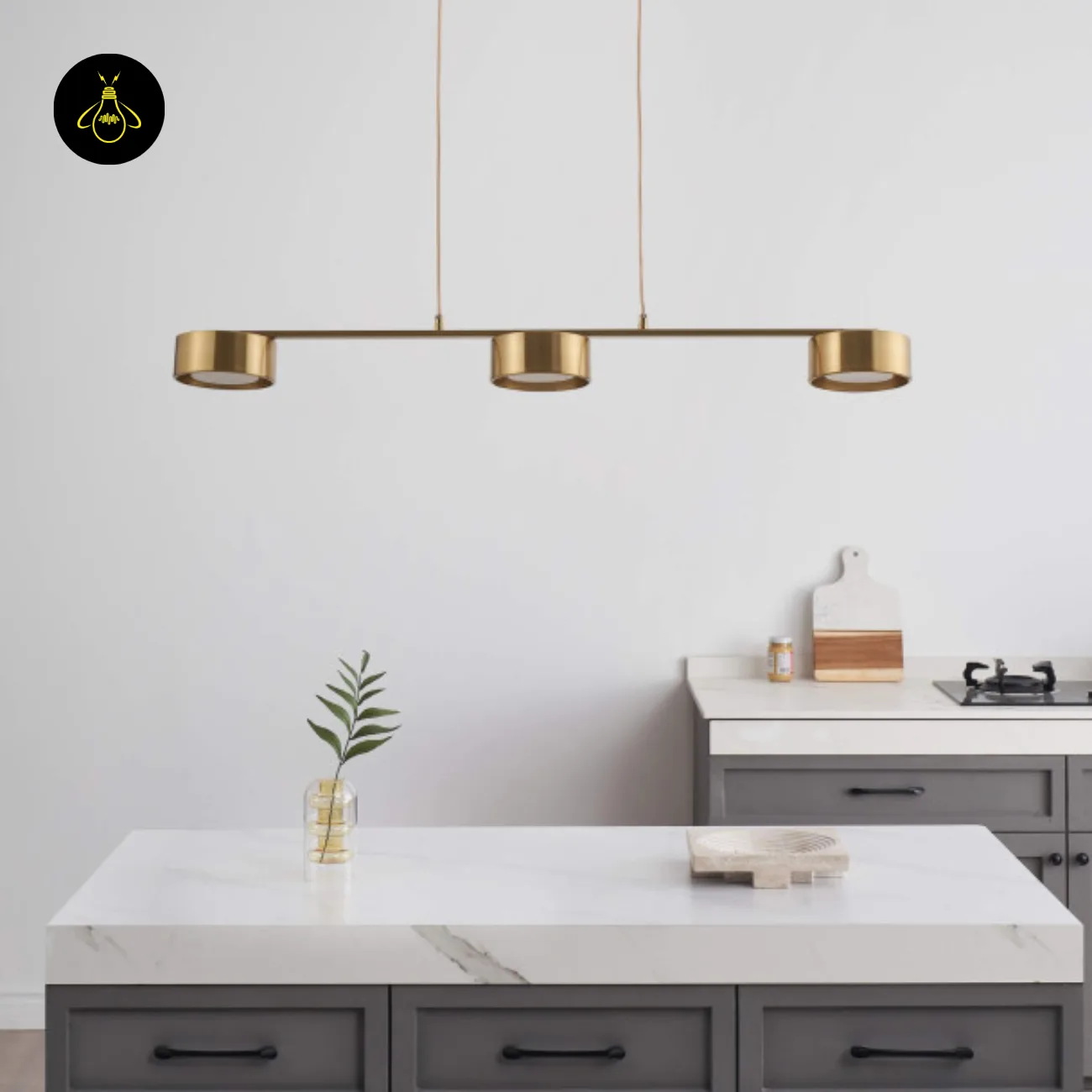 Linear Brass Chandelier – Triple Drum Spots, 108 cm | Jagmag Lights 8 Linear brass chandelier casting warm focused spots over an island counter – Jagmag Lights