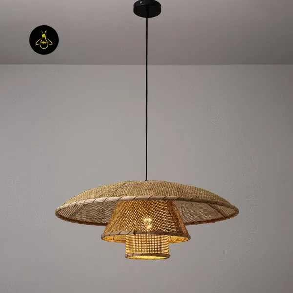 Front view of the lit rattan ceiling light: wide woven brim, cone and small drum on a black cord