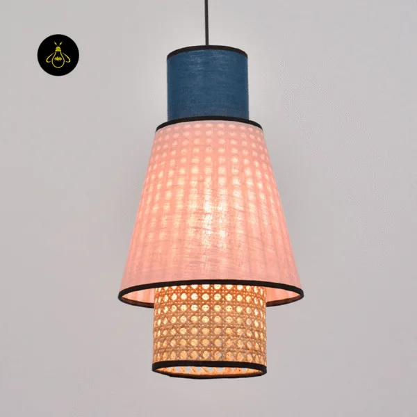 Floral fabric pendant light glowing through its natural cane weave base with warm light