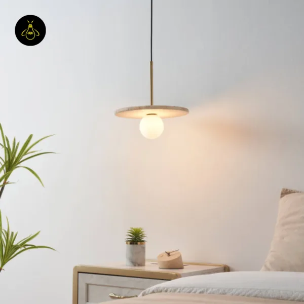 Stone pendant light hanging beside a bed over a nightstand, giving a warm glow