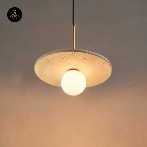 Stone pendant light glowing against a grey plaster wall, travertine disc seen from slightly below