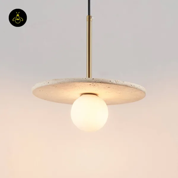 Stone pendant light switched on, the opal borosilicate glass globe glowing under the travertine disc