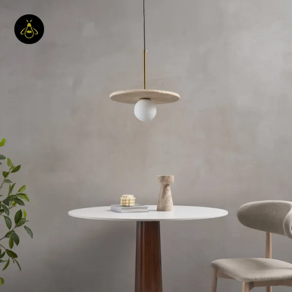 Stone pendant light switched off over a round dining table against a grey wall
