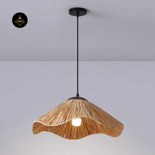 Straw lamp hanging from a black ceiling canopy, angled view of the wavy woven shade