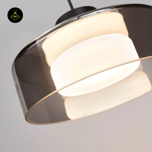 Close-up of the smoked glass drum pendant light rim and the glowing opal borosilicate glass core