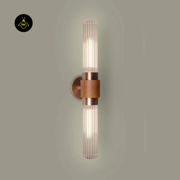 Fluted glass wall light switched on, warm light glowing up and down through clear fluted borosilicate glass with wood band and copper-finish collars
