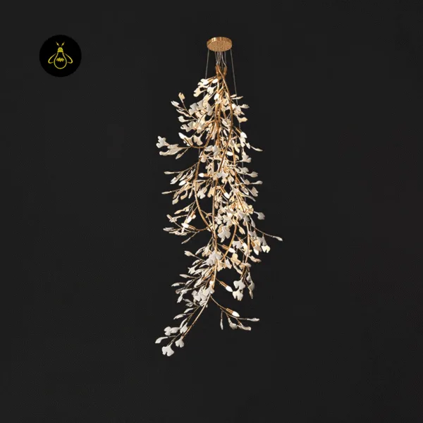 Illuminated ceramic leaf chandelier showing warm LED glow through white ginkgo leaves
