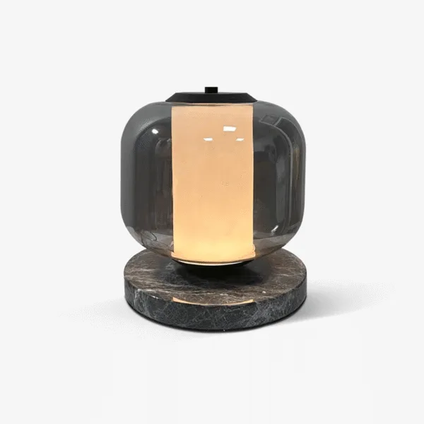 Black marble table lamp with smoked borosilicate glass shade and warm opal glow