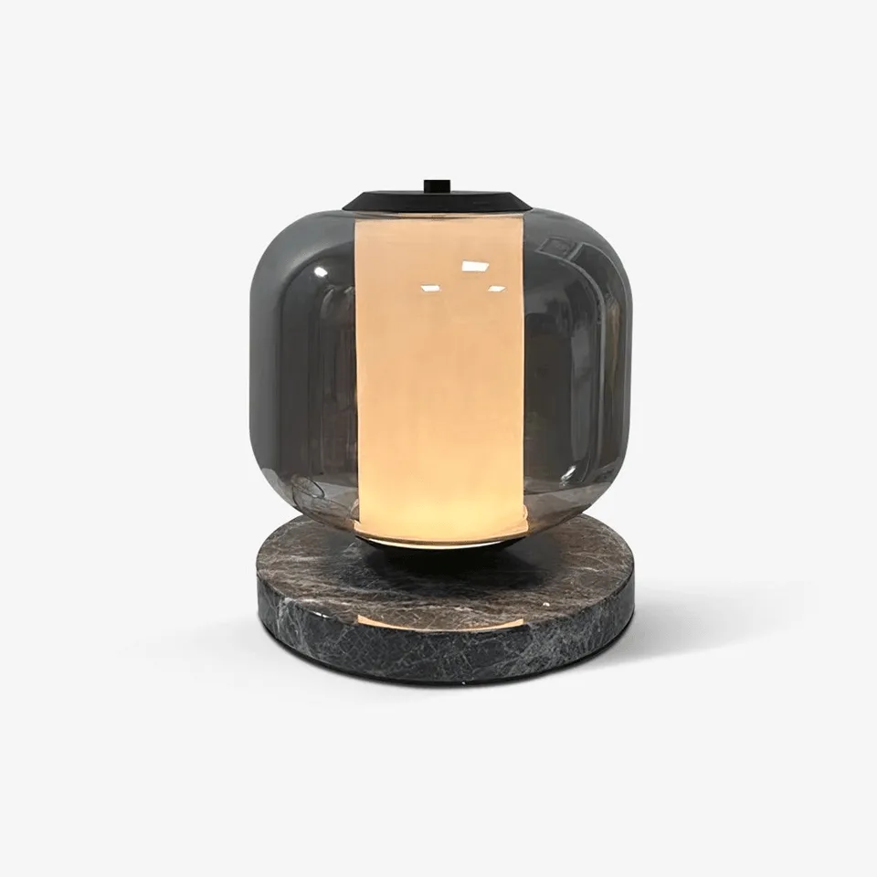 Black marble table lamp with smoke glass shade and warm opal glow