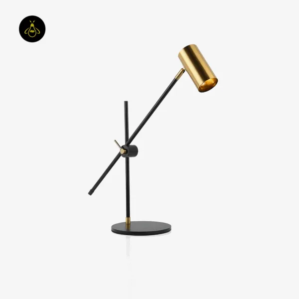 Brushed brass and black gold desk lamp with cylindrical spot head, studio view
