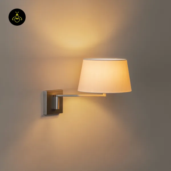 Swing arm wall lamp switched on, linen shade glowing warm up and down the wall, satin nickel backplate