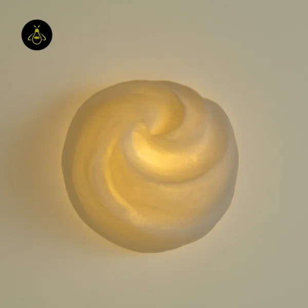 Close-up of the alabaster swirl lit from inside, sculptural wall light front