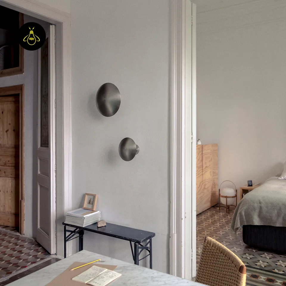 Round LED Wall Light – Satin Nickel Eclipse Disc, 24 cm Warm White Halo 9 Pair of LED wall lights above a black console table in a hallway that opens onto a bedroom