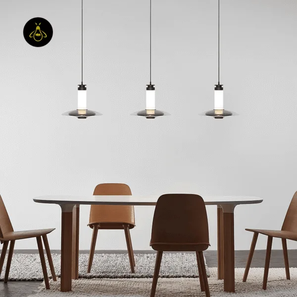 Three black glass hanging lights, Model B, in a row over a wooden dining table