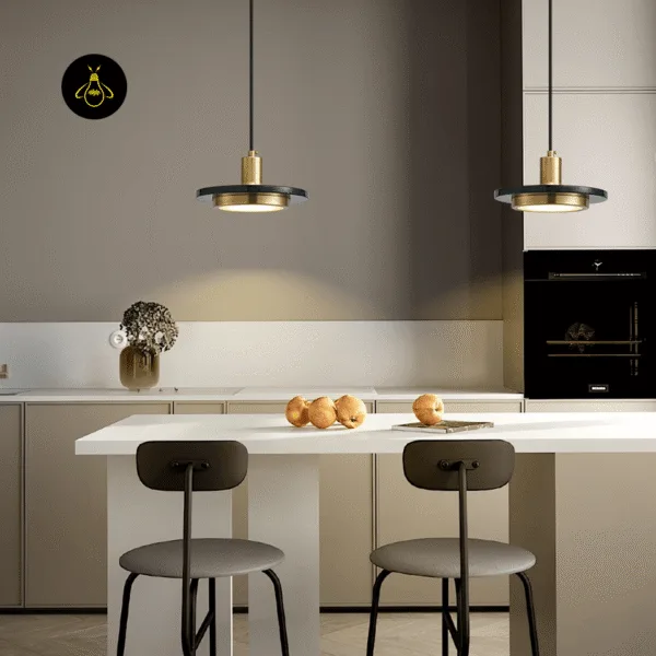 Two black marble pendant lights over a white kitchen island with bar stools