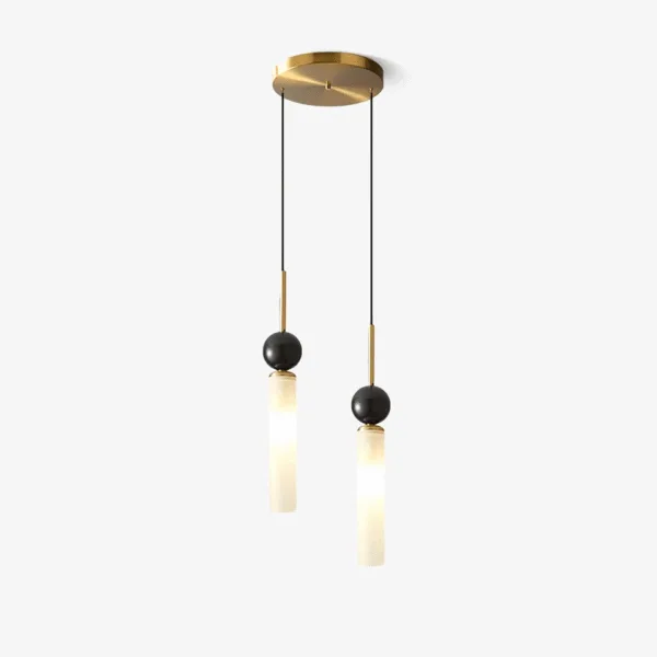 Double marble pendant light: two white marble cylinders under black marble spheres on brass-finish stems from one round canopy