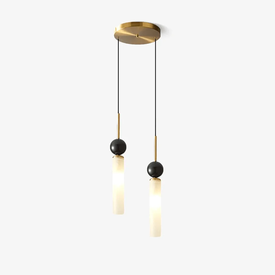 Marble pendant light with a glowing white-marble cylinder, black-marble ball and brass stem