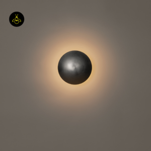 Round LED wall light close-up casting a warm-white halo around the satin nickel disc