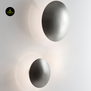 Pair of round LED wall lights flanking a bedroom wall with a warm-white halo