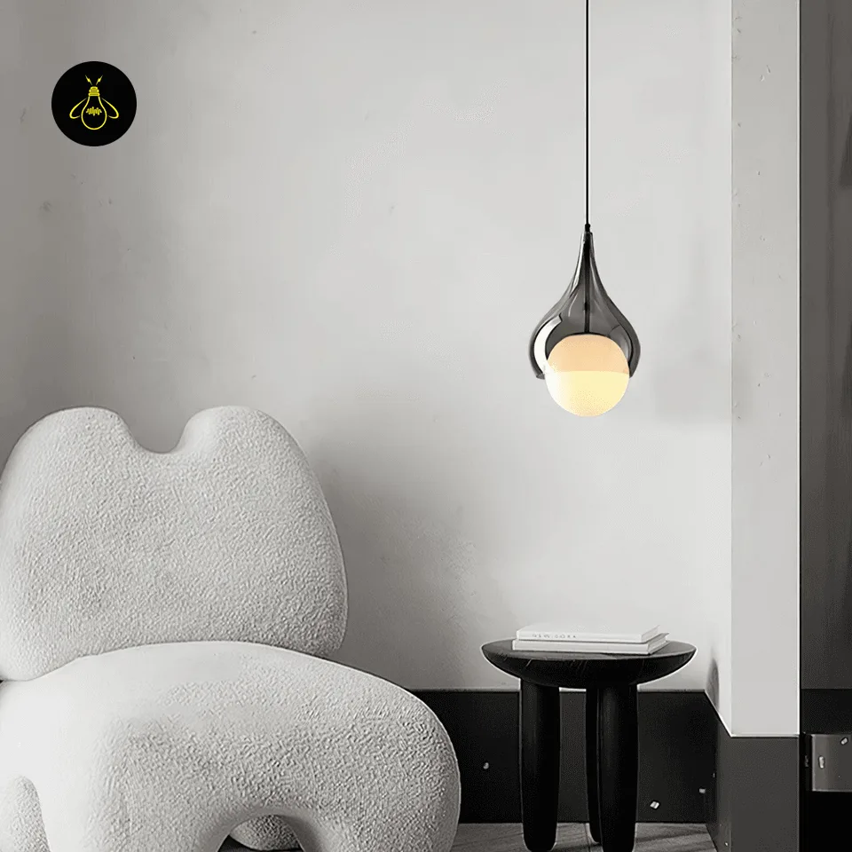 Smoked Glass Teardrop Pendant Light – 20 cm Hanging Bedside Light with Opal Globe 6 Hanging bedside light in smoked borosilicate glass over a small side table beside a lounge chair
