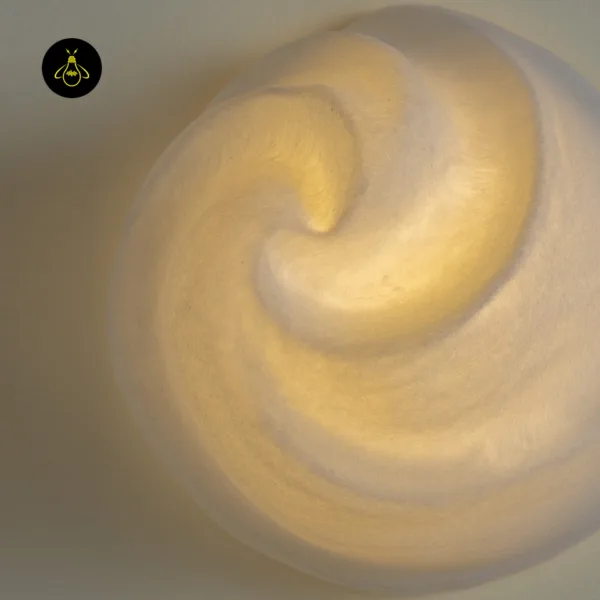 Macro of the hand-carved alabaster surface and swirl on the sculptural wall light