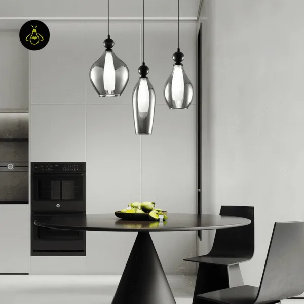 Three black smoked glass pendant lights hanging over a round table in a modern kitchen