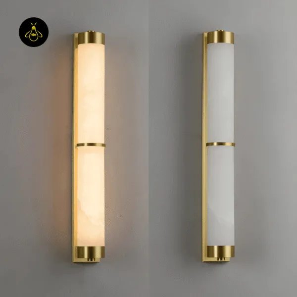 Pair of alabaster wall lights side by side, one lit warm and one switched off to show the white stone