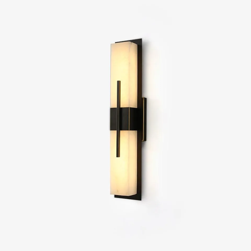 Alabaster outdoor wall light glowing warm beside a garden pathway entrance