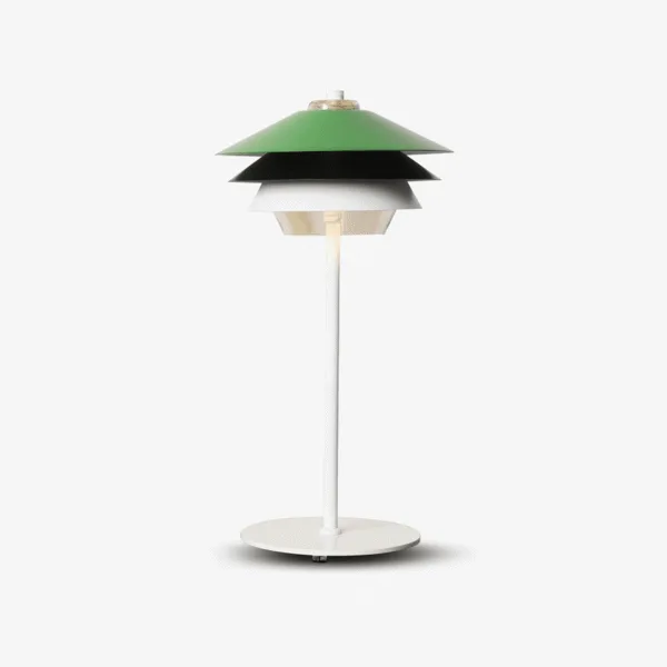 Green overlay table lamp with layered green, black and white louvre shade and glass diffuser
