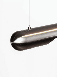 Stainless steel linear LED chandelier close-up with warm downward light strip