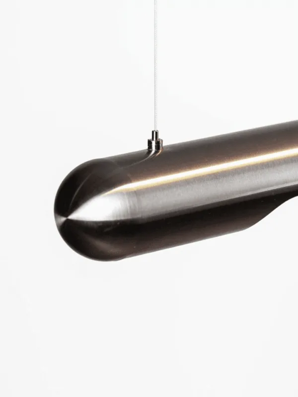 Stainless steel linear LED chandelier close-up with warm downward light strip