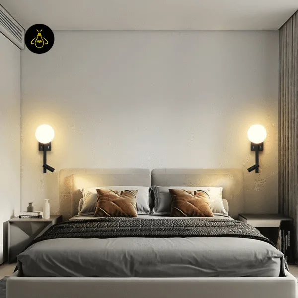 Pair of wall mounted study lamps on either side of a bed, opal globes glowing warm