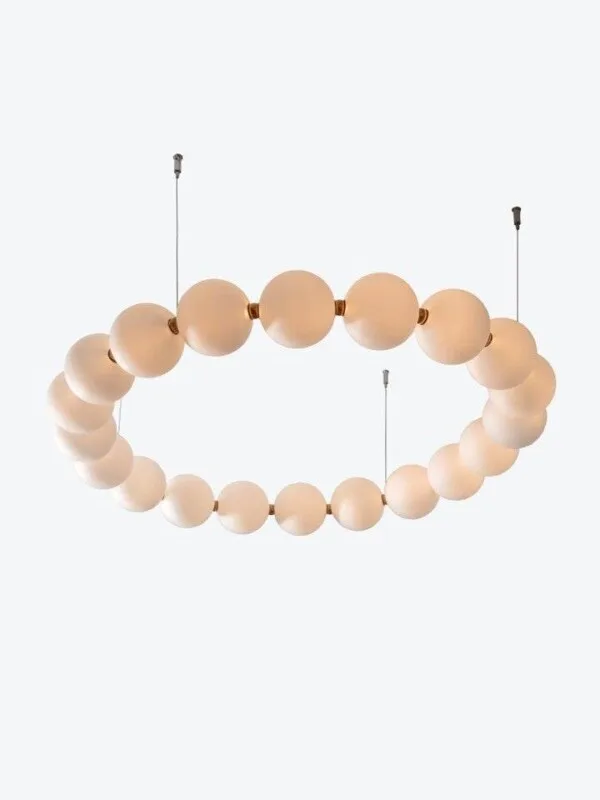 String pearl chandelier with milk-glass globes and brushed-brass connectors